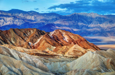 Scenic view of mountains against cloudy sky