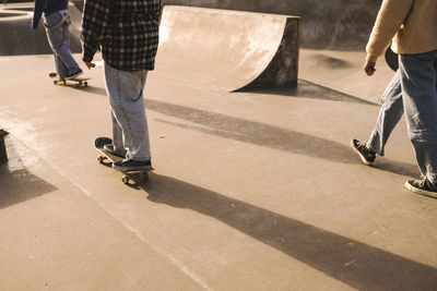 Teenage girls skateboarding in skatepark