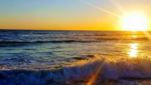 Scenic view of sea against clear sky during sunset