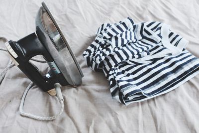 High angle view of shoe on bed