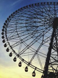 Low angle view of ferris wheel against sky