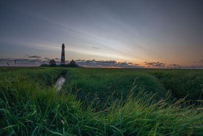 Scenic view of field against sky during sunset