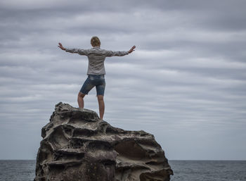 Silhouette of man jumping in water