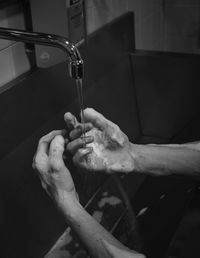 Close-up of man hand in water