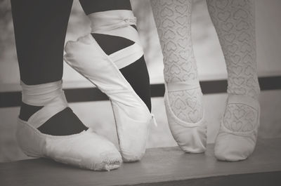 Low section of ballerinas dancing on table