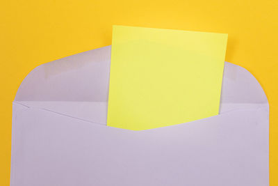 Close-up of yellow paper against white background