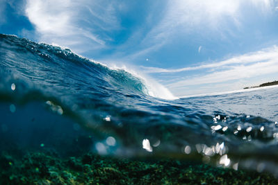 Blue wave breaking over the coral reef