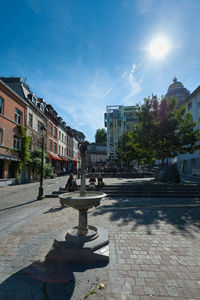 Street amidst buildings in town against sky