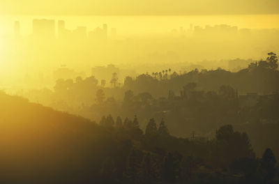 Scenic view of mountains against orange sky