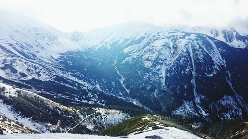 Scenic view of mountains against sky during winter