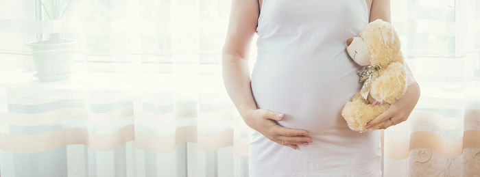 Midsection of woman holding hands