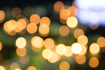 Defocused image of illuminated christmas lights at night