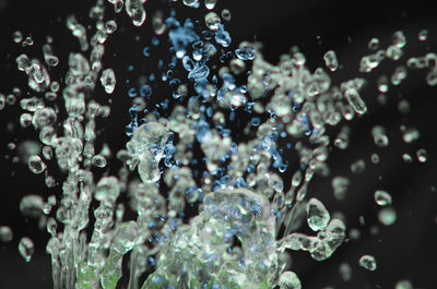 Close-up of water splashing against black background