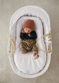 Newborn baby boy sleeping in cot