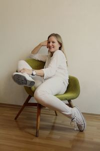 Woman sitting on table at home