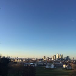 View of cityscape against clear blue sky