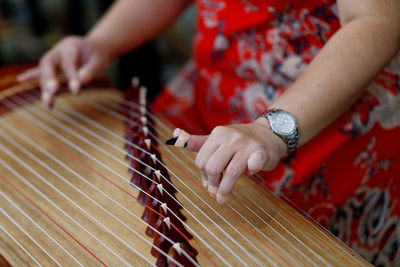 Midsection of person playing musical instrument