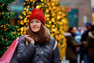 Portrait of smiling young woman in park during winter