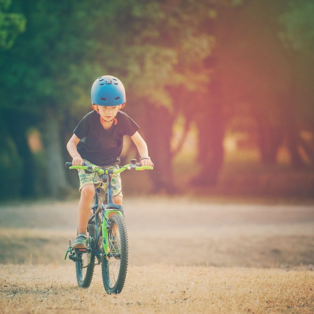 child, childhood, one person, real people, transportation, helmet, headwear, lifestyles, day, leisure activity, ride, bicycle, focus on foreground, riding, front view, full length, innocence, nature, cute, outdoors