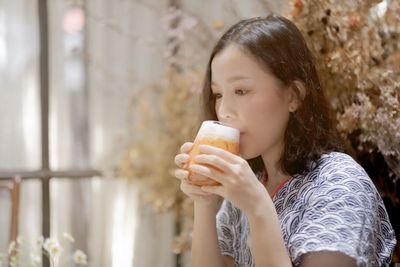 Portrait of woman drinking water from outdoors