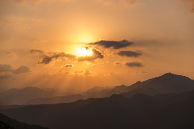 Scenic view of silhouette mountains against sky during sunset