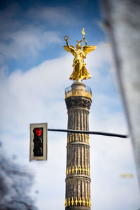 Low angle view of statue against cloudy sky