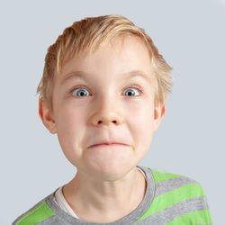 Close-up portrait of boy against white background