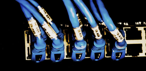 Close-up of illuminated lighting equipment against black background