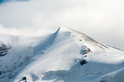 Scenic view of snow covered mountains against sky