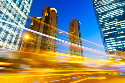 Low angle view of illuminated buildings against sky in city