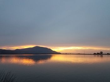 Scenic view of lake against sky during sunset