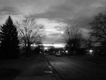 Empty road against cloudy sky