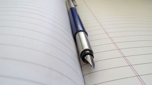 Close-up of pen on book