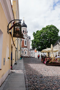 Street amidst buildings against sky