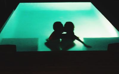 Silhouette couple in illuminated room