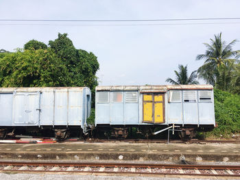 Train by railroad tracks against sky