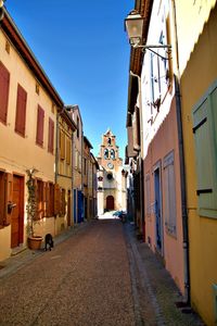 Empty alley amidst buildings in city