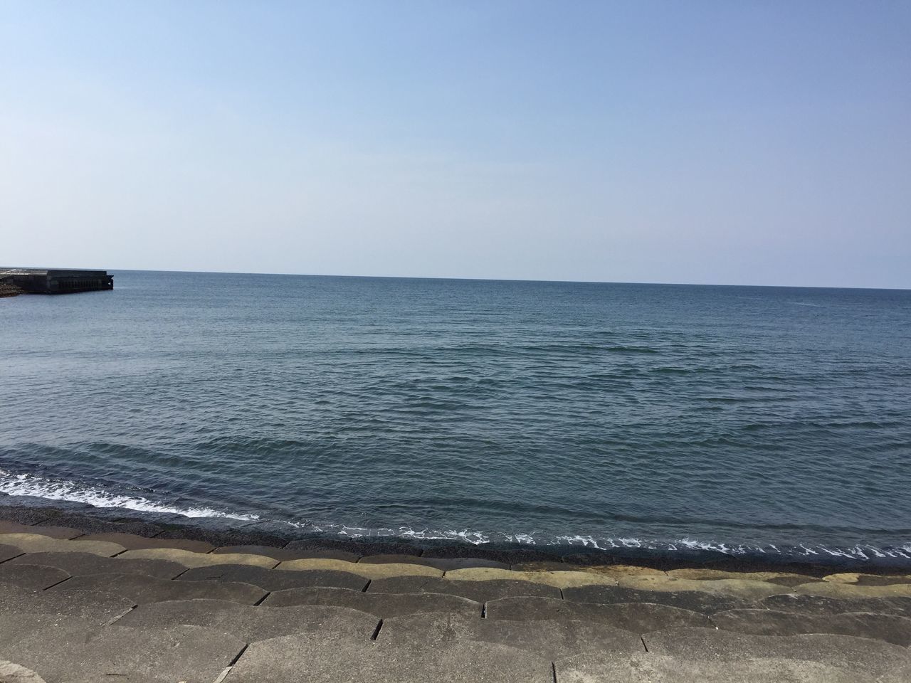 sea, water, clear sky, copy space, beach, horizon over water, tranquil scene, tranquility, scenics, beauty in nature, shore, nature, sand, blue, coastline, idyllic, calm, sky, remote, day