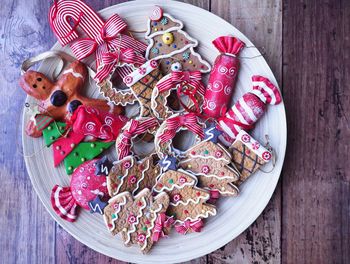 Directly above shot of gingerbread cookies and candies on table during christmas