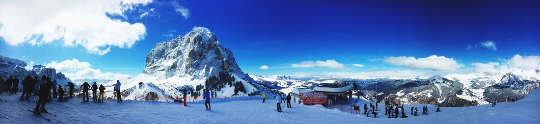 Panoramic view of snowcapped mountains against blue sky