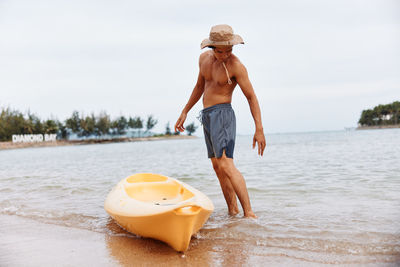 Rear view of woman standing on beach