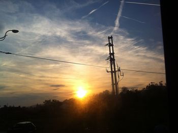 Low angle view of power lines against sky