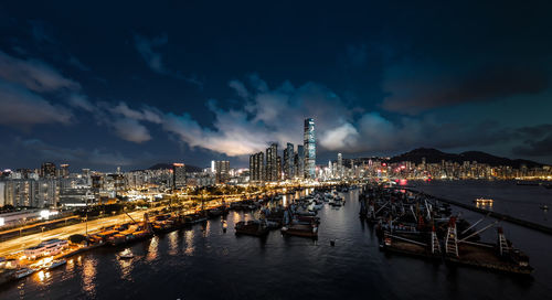 Illuminated buildings in city against sky at night