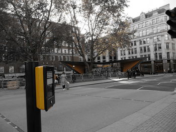 Cars on road by buildings in city