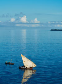 Traditional african sailing boat in open sea during the day.