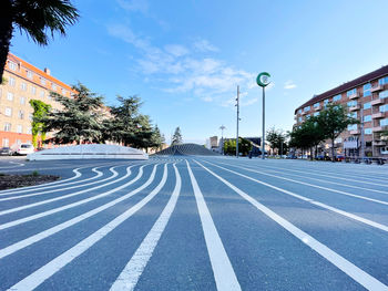 View of city street against blue sky