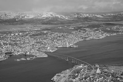 High angle view of townscape by sea against sky