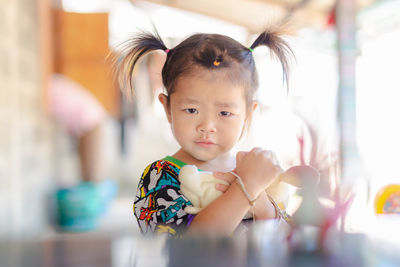 Portrait of cute girl with toy