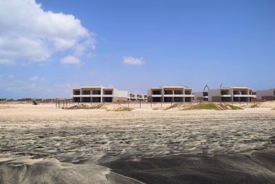 House on beach against sky