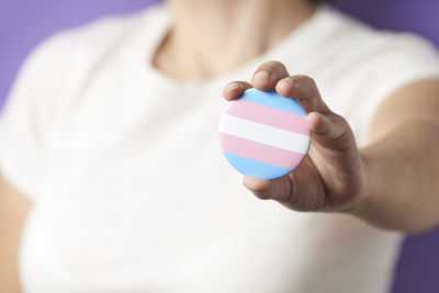 Midsection of woman holding pills